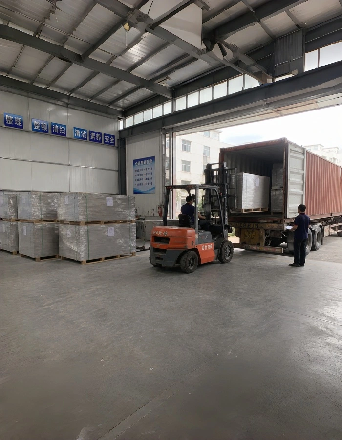 Paperboard packed on a pallet with corner protection and wrapping, ready for export